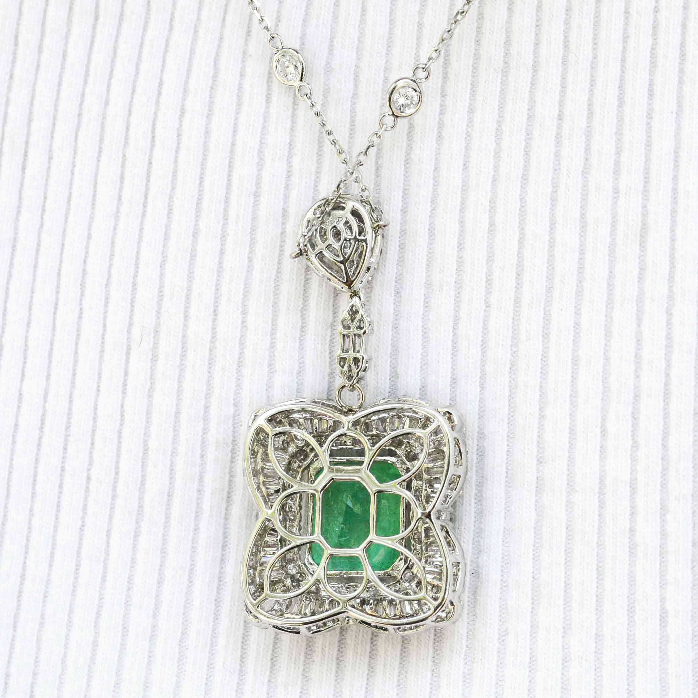 The emerald cut gem of nearly 8 carats glows with a vivid green fire in this white gold pendant necklace.