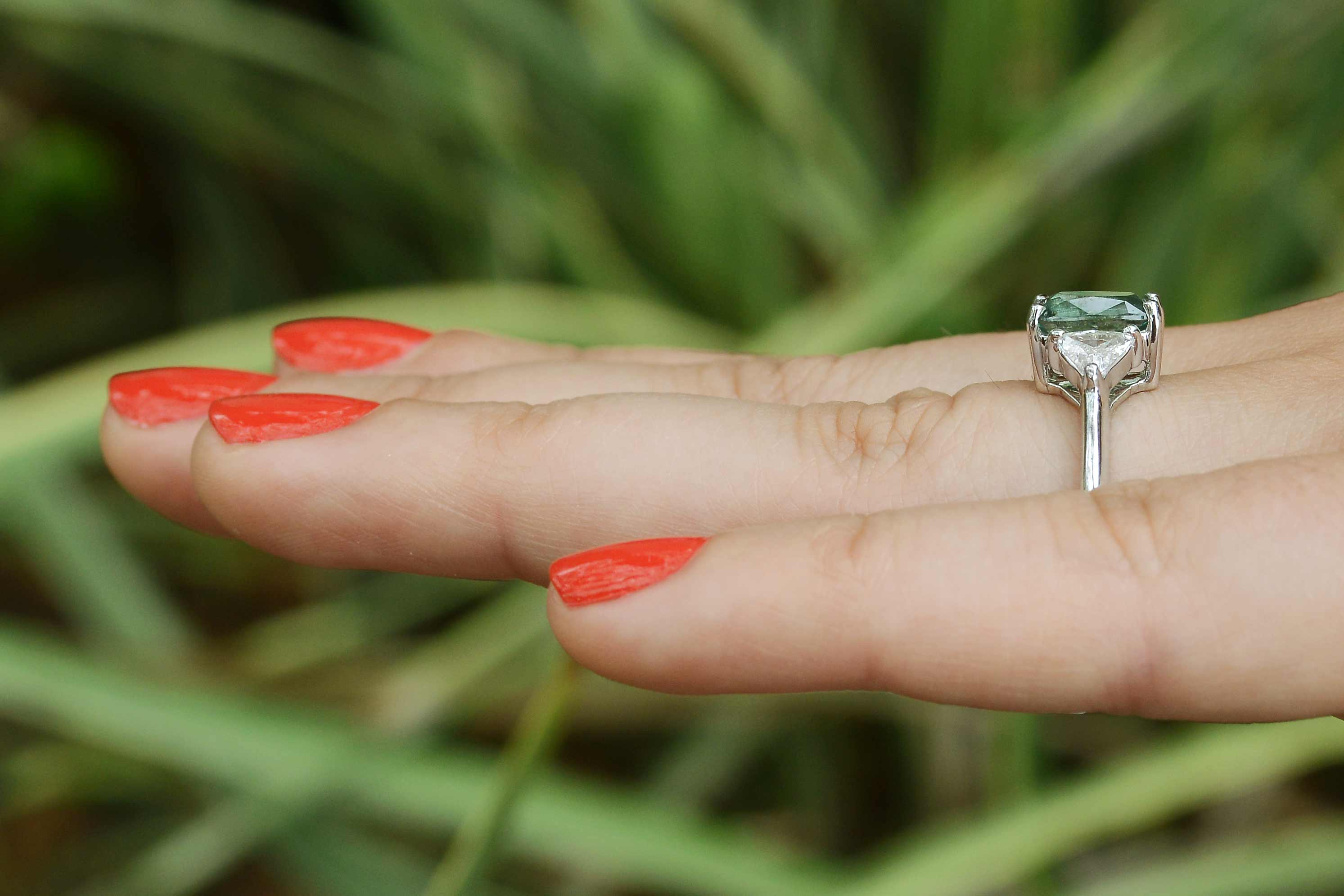 There is nearly a half carat of trillion cut accent diamonds in this 14k white gold alexandrite bridal ring.