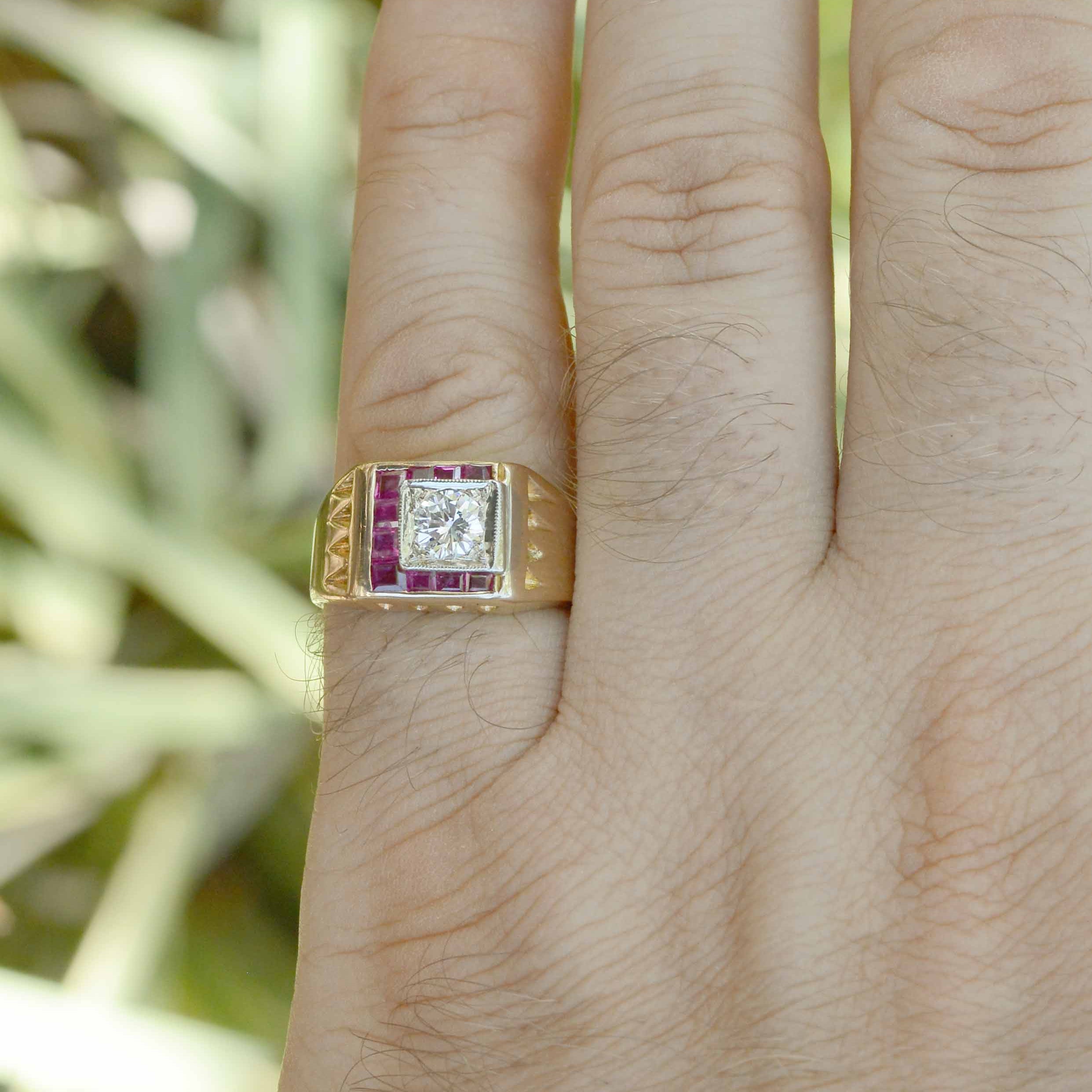 The center gemstone is a glimmering round brilliant cut diamond which is distinctively accented by 10 bezel set rubies.