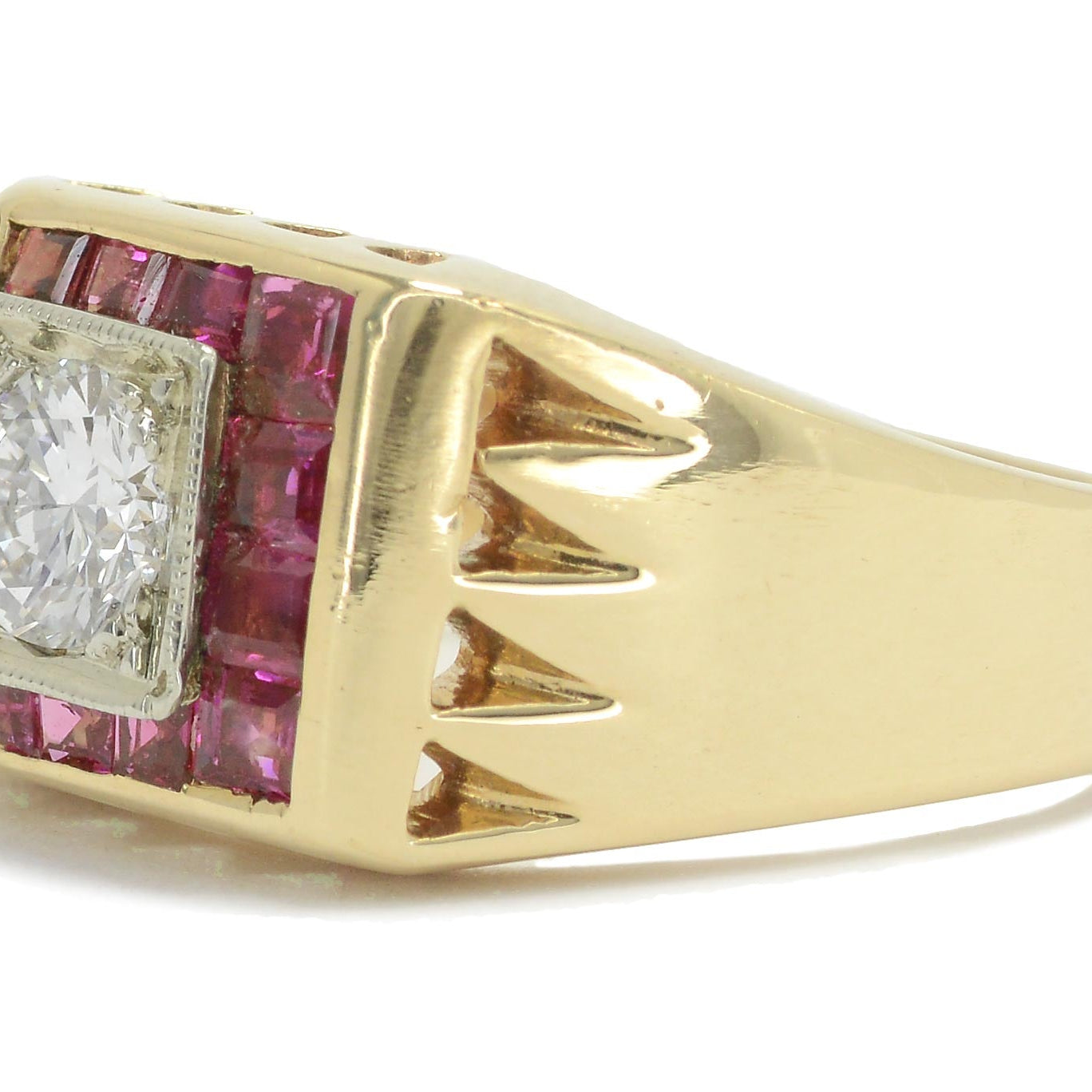 The rich, red rubies are placed in a unique square band setting surrounding the diamond.