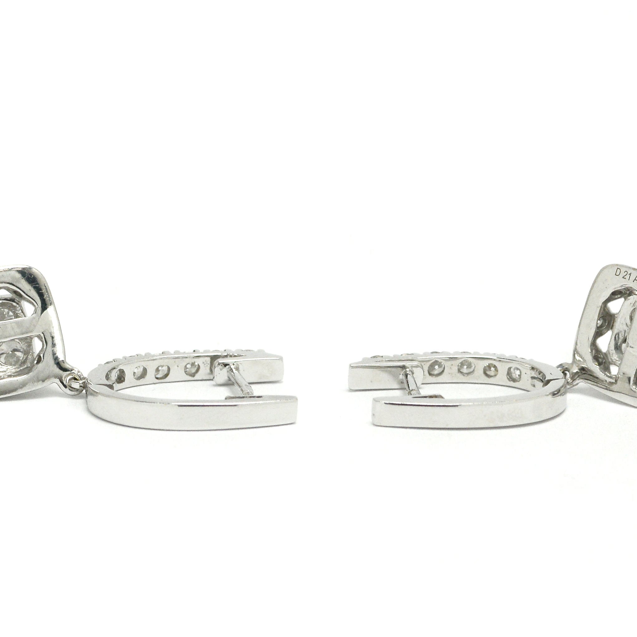 White gold horseshoe latch earrings lined with diamonds.