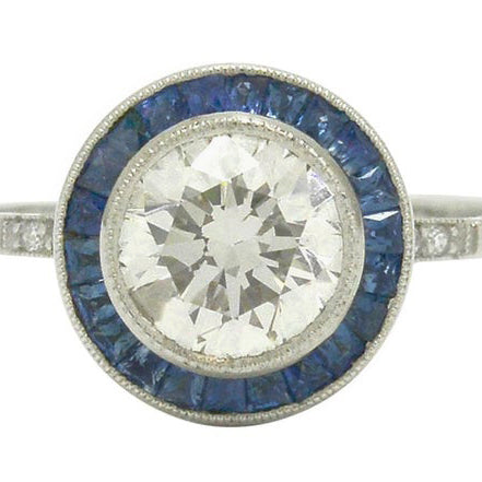 One and half carat diamond engagement ring with sapphire halo.