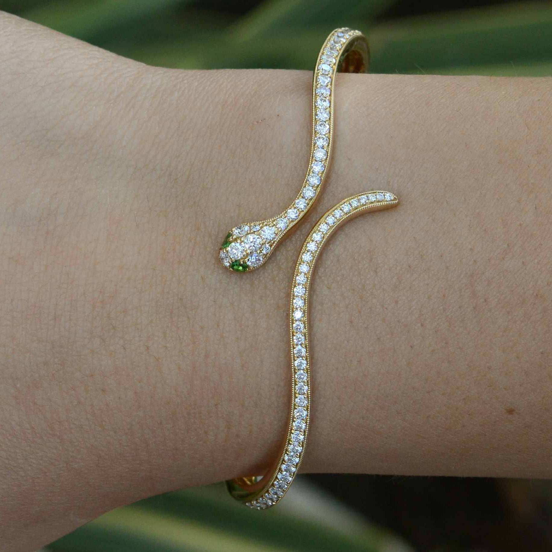 Nearly 1 and a half carats of round diamonds line this thin modern snake bracelet.