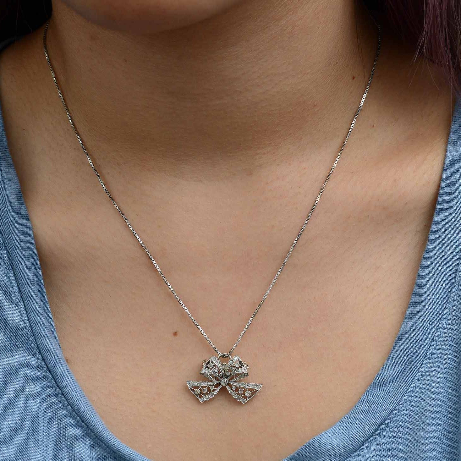 Rose and table cut diamonds on an antique diamond ribbon pendant.