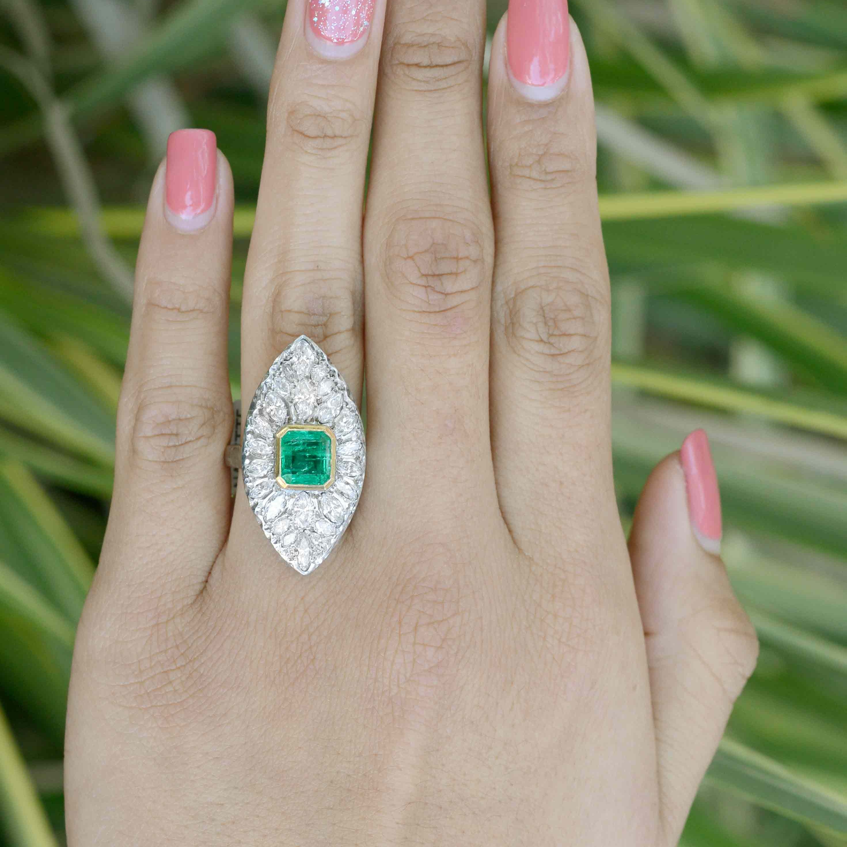 A two carat emerald and diamonds boat shaped statement ring.