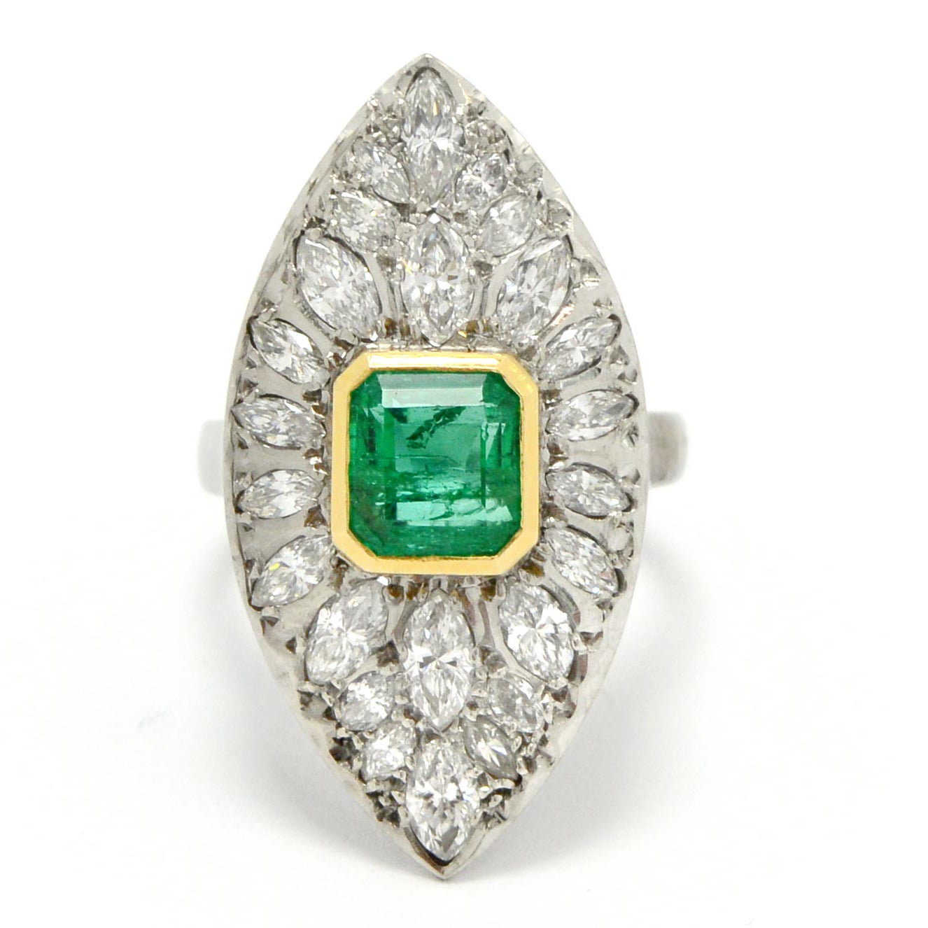 A stunning retro era estate cluster ring featuring a 2 carat Colombian emerald.