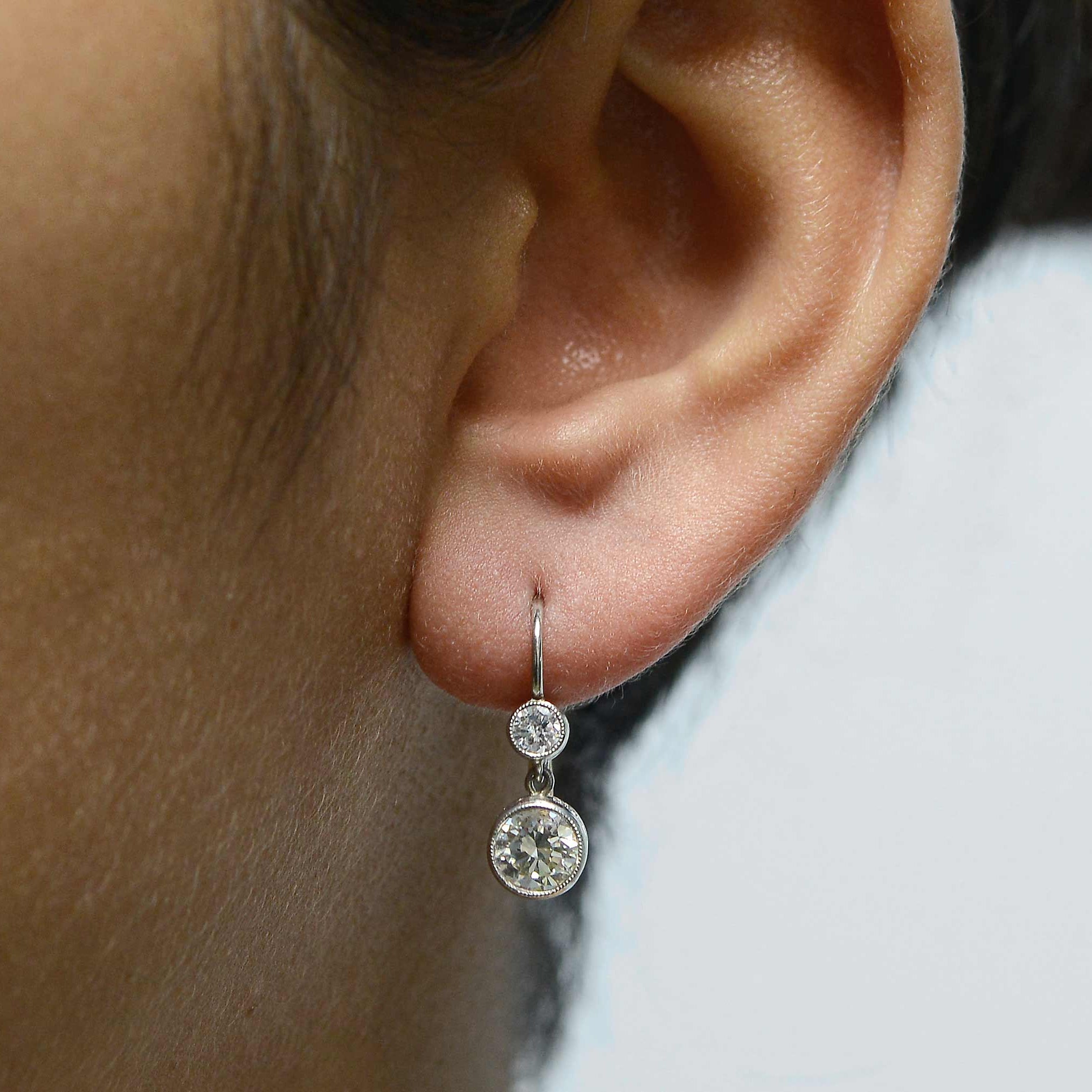 Victorian revival, platinum antique drop earrings with 2 diamonds.