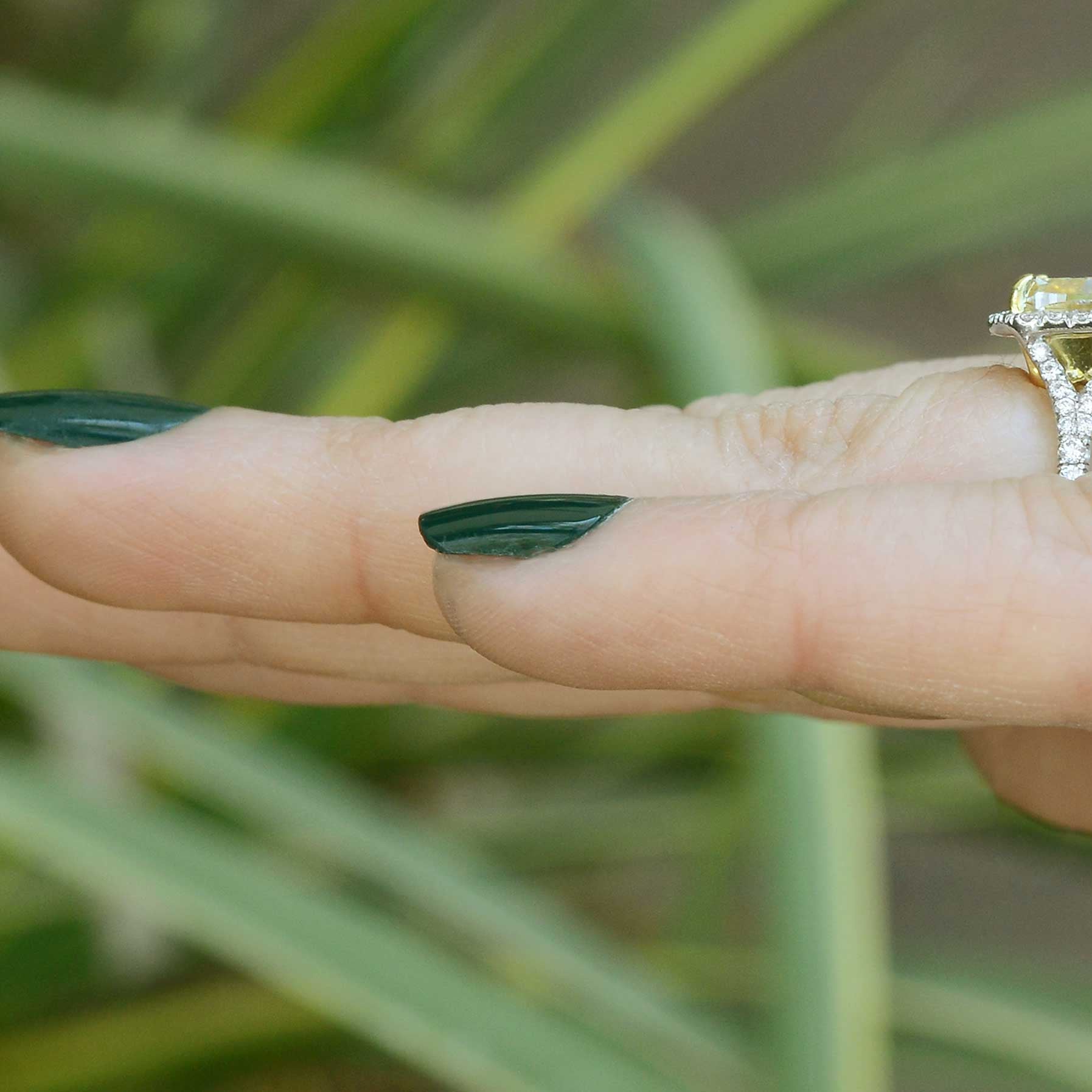 A unique yellow diamond engagement ring with a platinum v shaped band.
