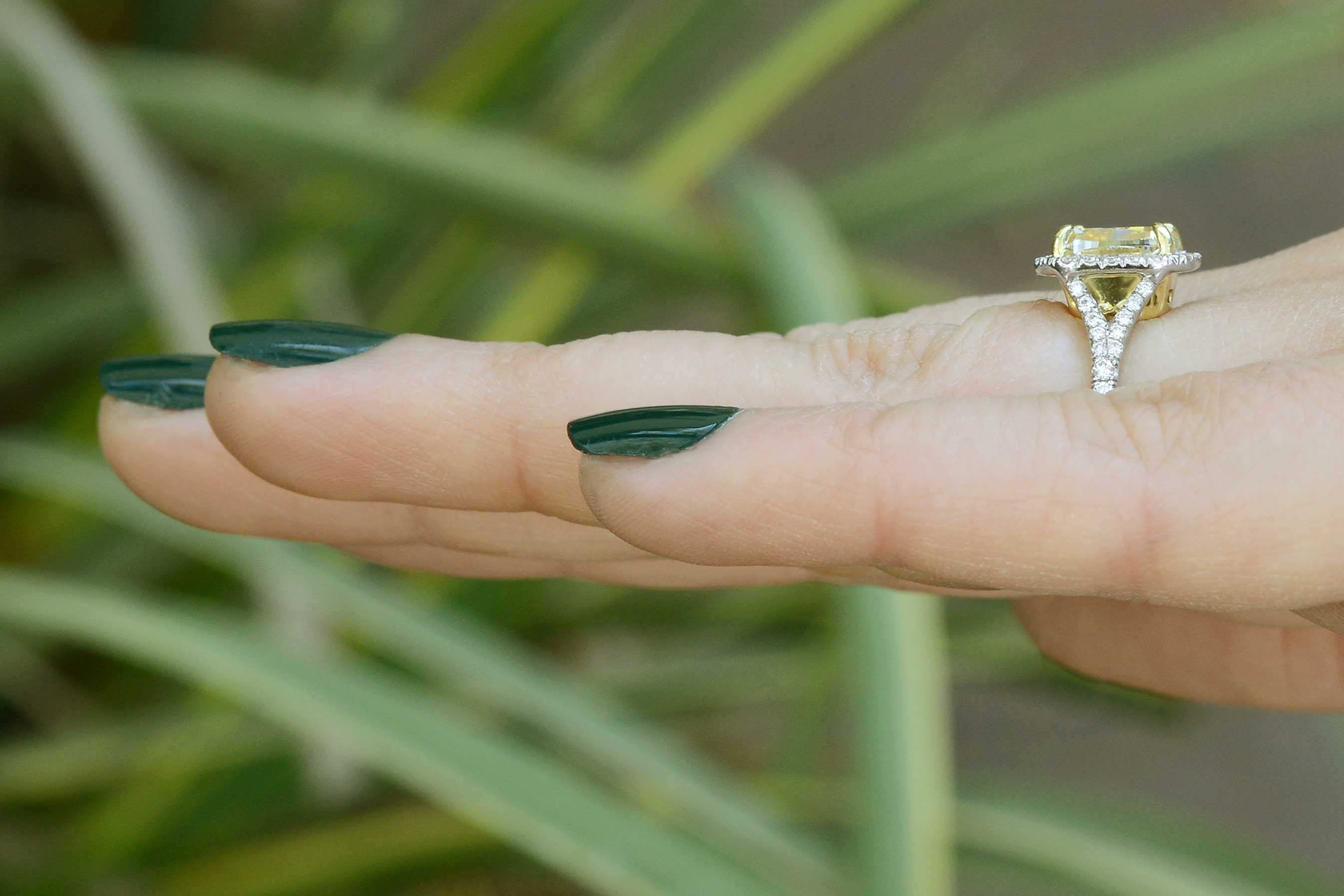A unique yellow diamond engagement ring with a platinum v shaped band.