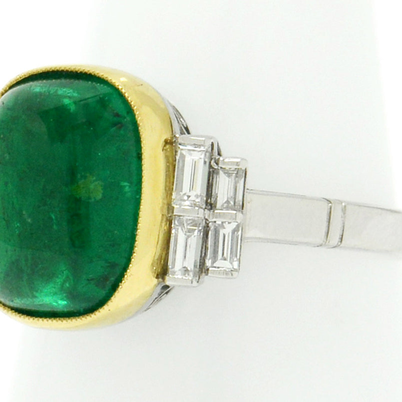 A new, platinum ring shank supports this large 4 carat emerald ring with 8 diamonds.
