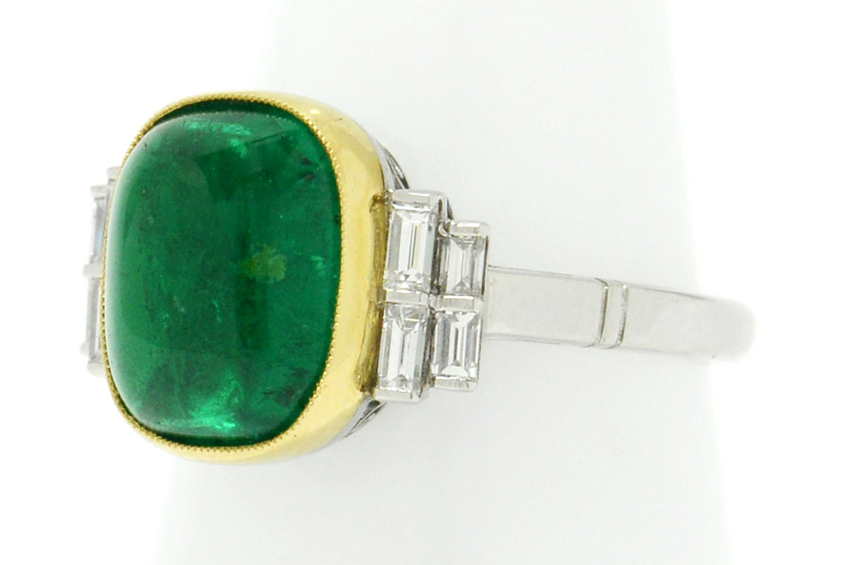 A new, platinum ring shank supports this large 4 carat emerald ring with 8 diamonds.