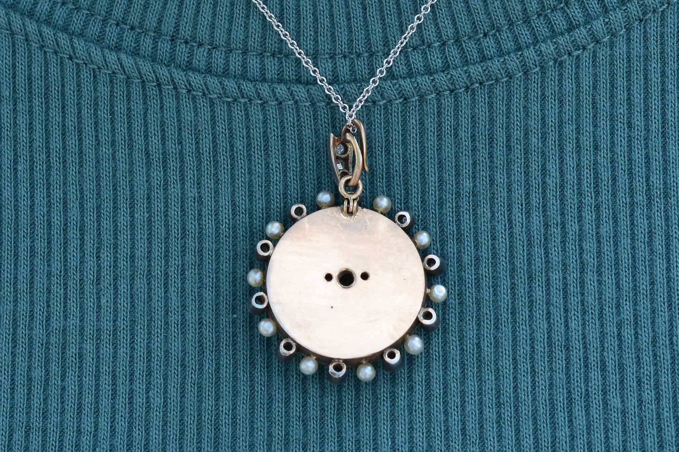 The backside of this pendant necklace is 14k rose gold.