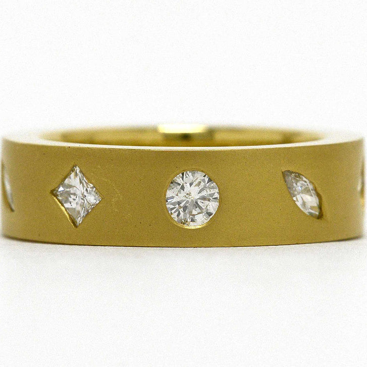 Round, princess and marquise diamonds set in a modern, 18k gold band.