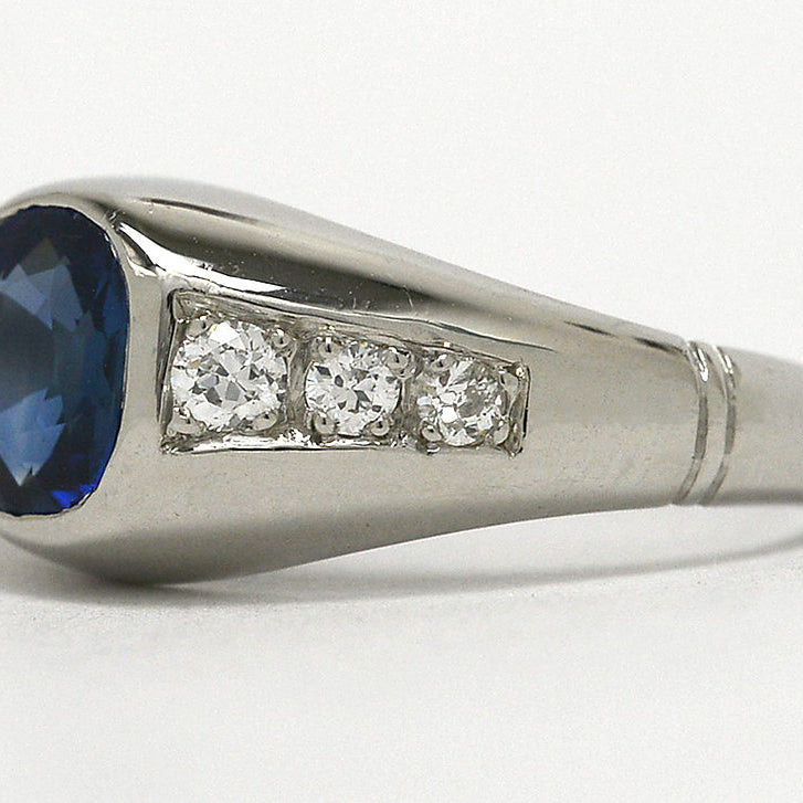 A 1930s cushion cut sapphire ring with six accent diamonds.