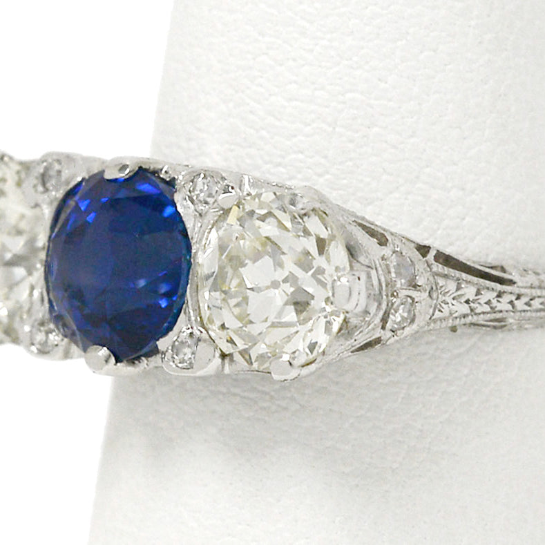 A platinum trinity 3 stone sapphire and diamonds engagement ring.
