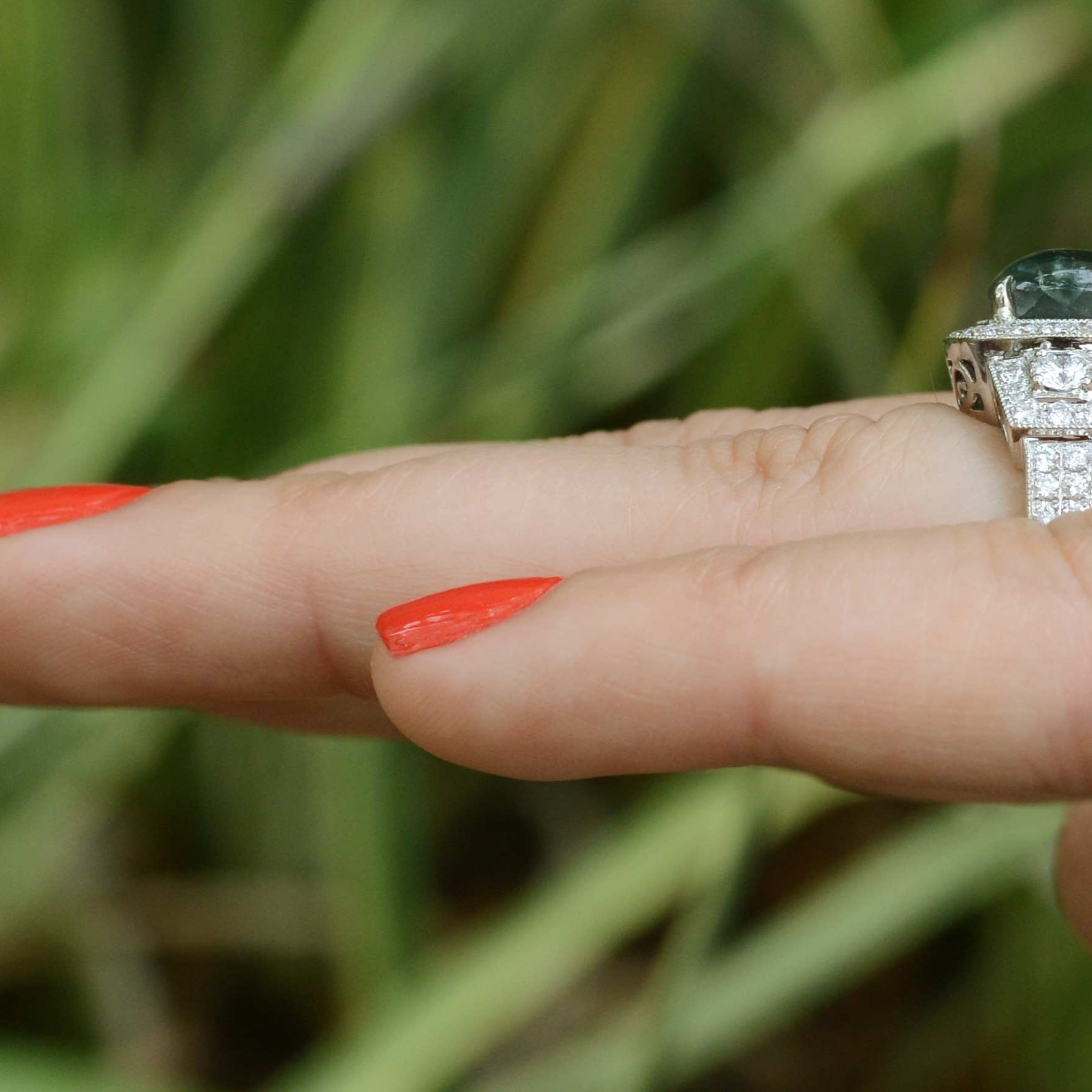 A contemporary four carat cabochon cut oval alexandrite engagement ring.