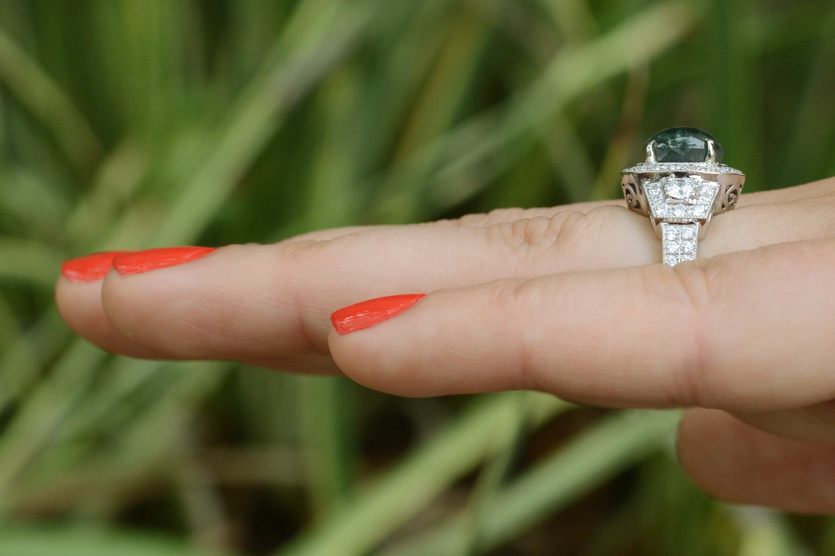 A contemporary four carat cabochon cut oval alexandrite engagement ring.