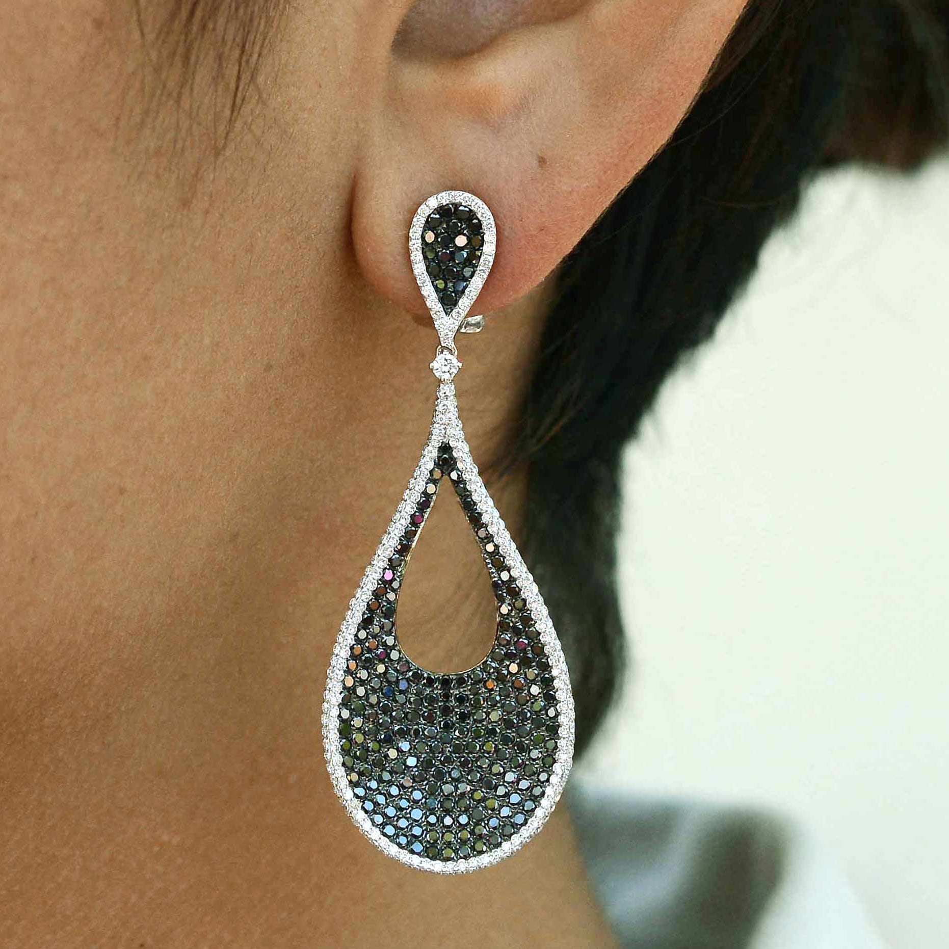 Black and white diamonds sparkling in a 2 inch teardrop earring design.