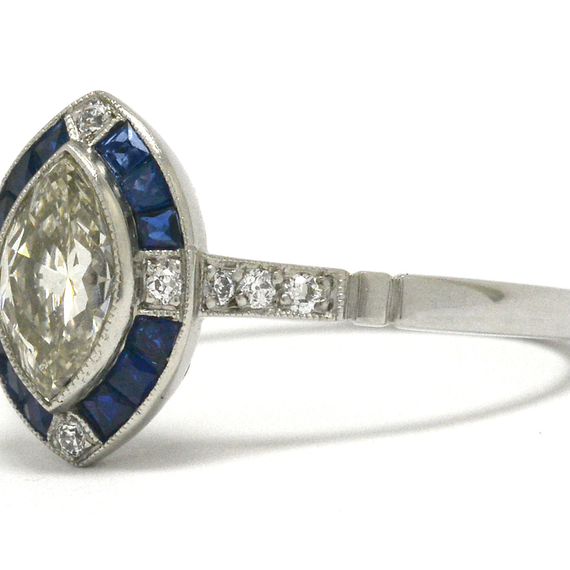 A four point diamond marquise engagement ring with sapphires.