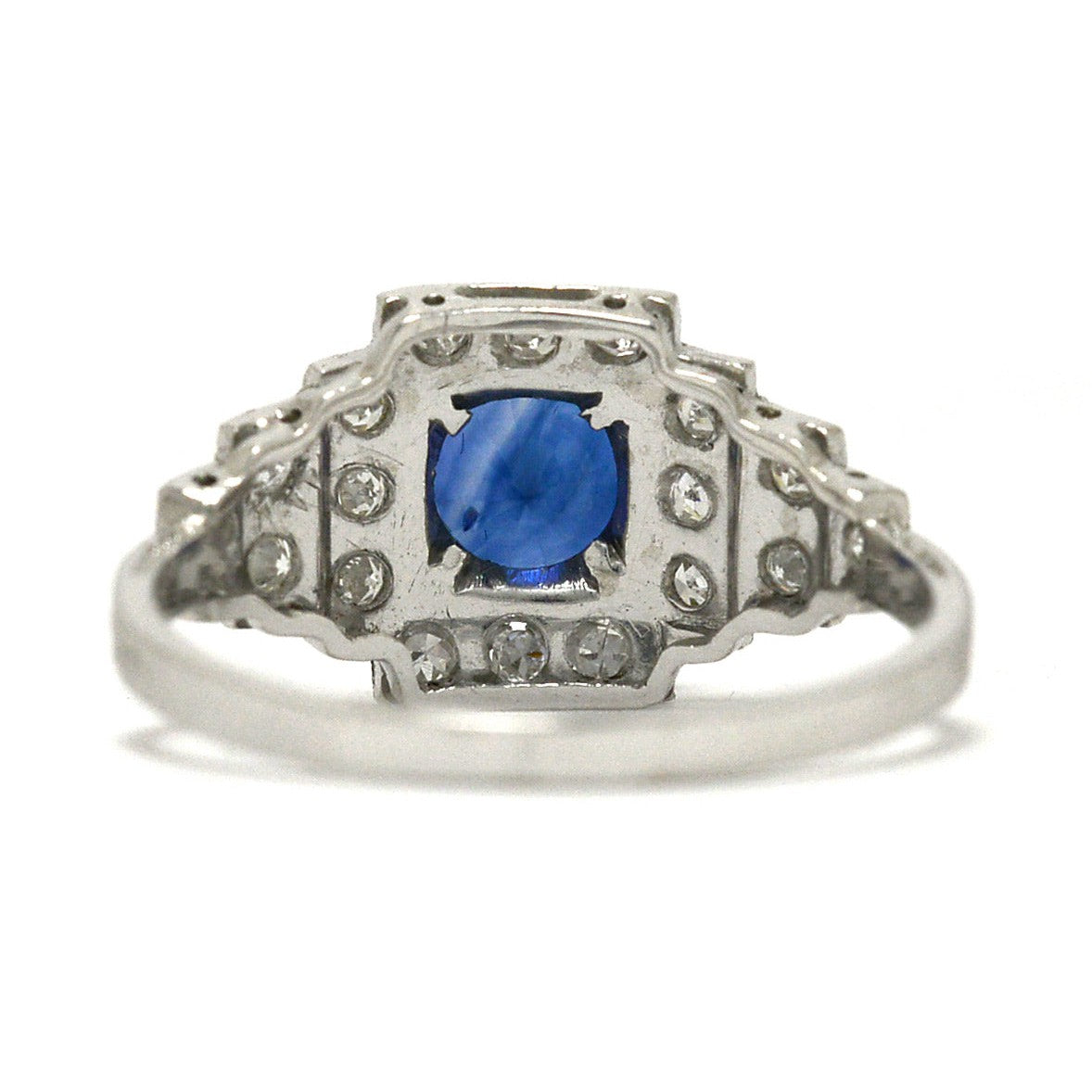 Antique, tiered round blue sapphire platinum engagement ring.