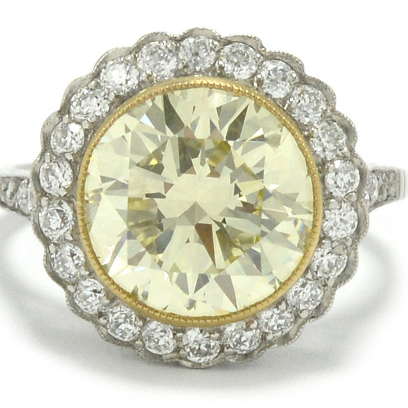 A nearly 5 carat yellow diamond halo engagement ring.