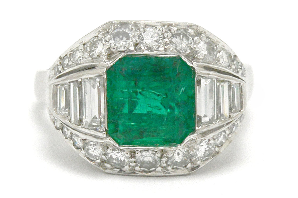An Art Deco emerald and diamonds palladium engagement ring.