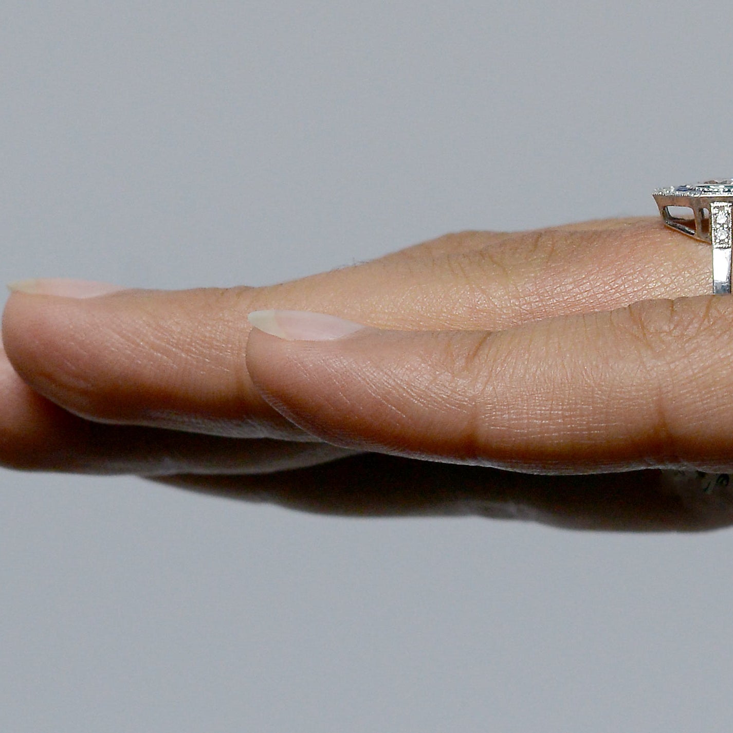 Diamonds on the band of the engagement ring.