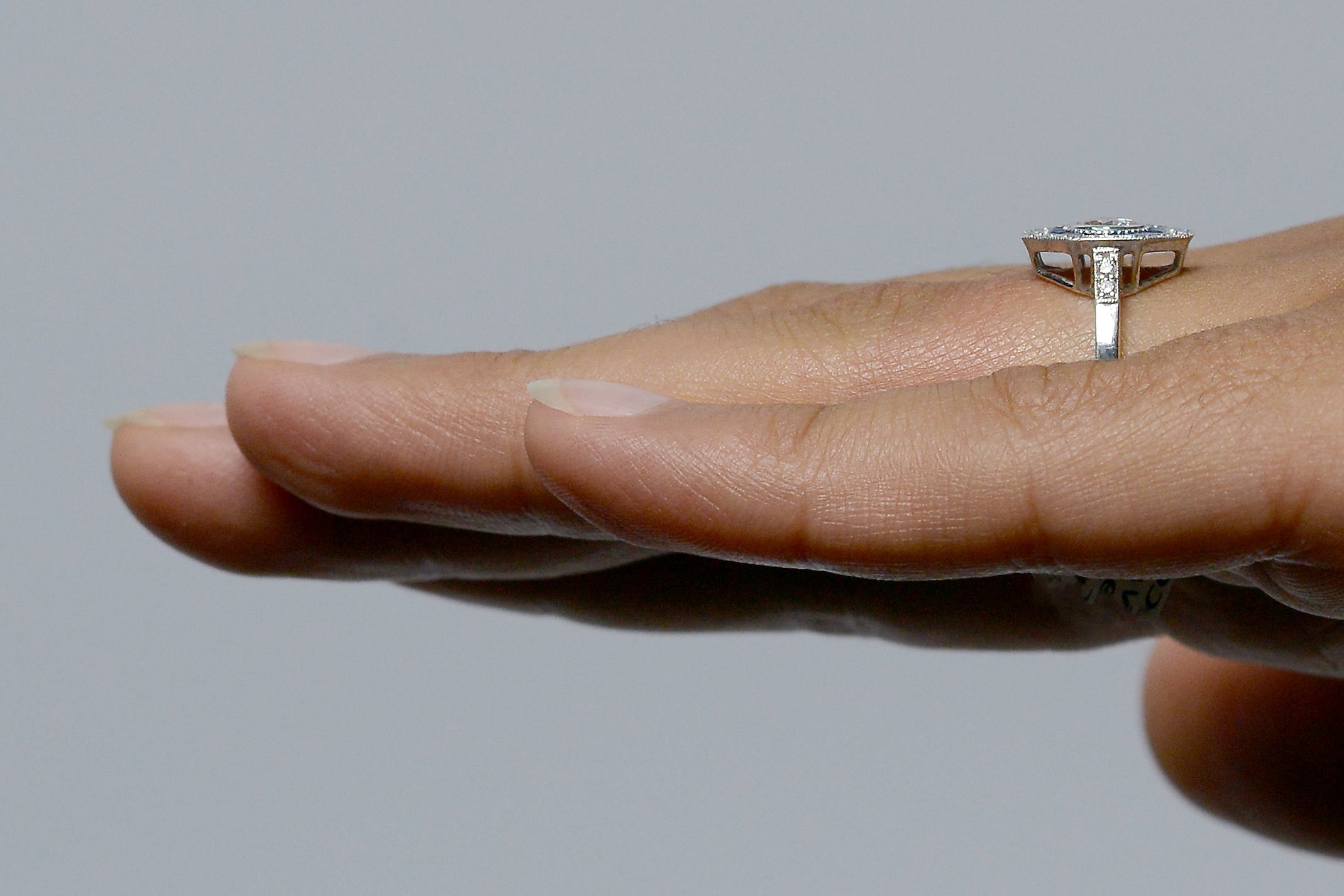 Diamonds on the band of the engagement ring.