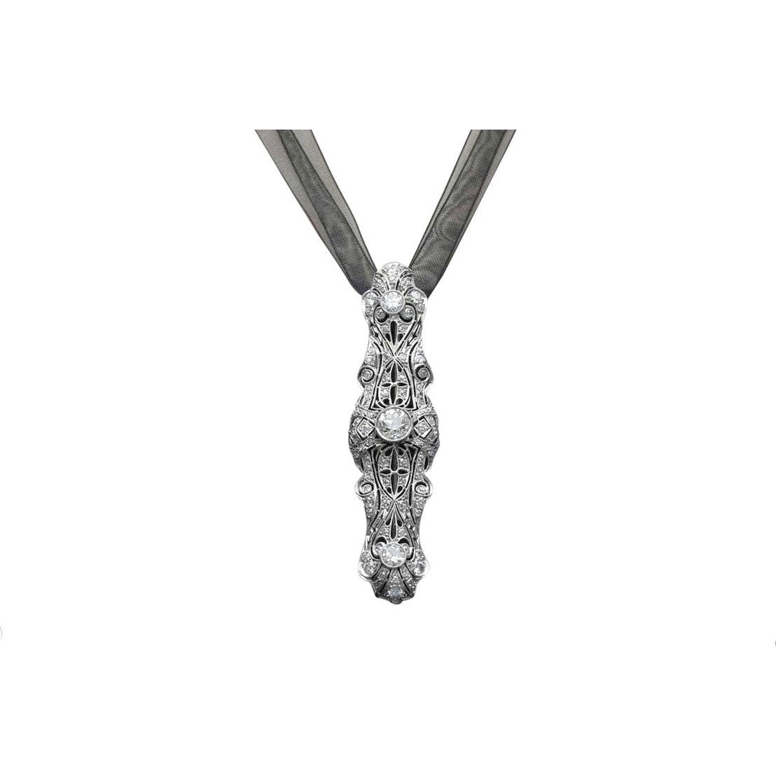 An Edwardian platinum diamond filigree brooch pin from the early 1900s.