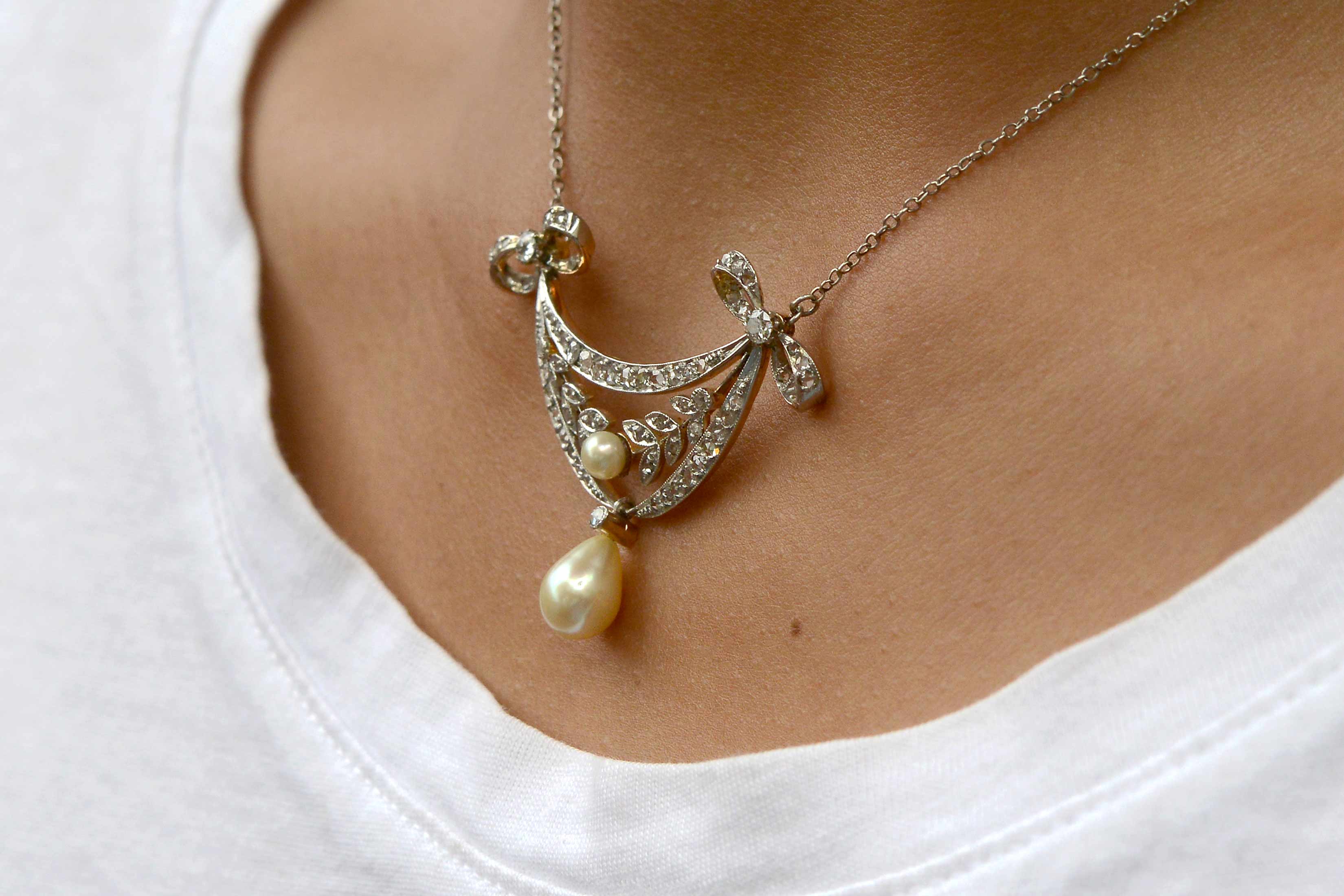 An antique diamonds drop lavalier necklace with two pearls.