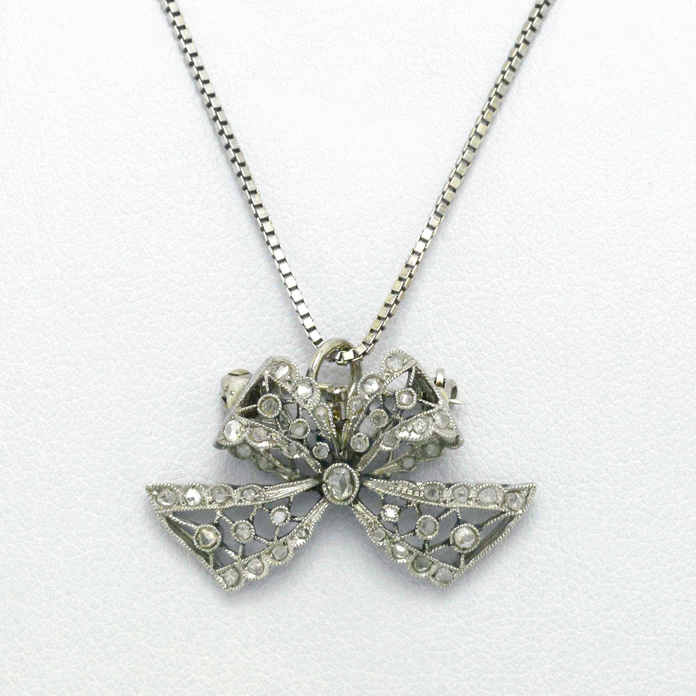 An antique Edwardian diamond bow platinum necklace.