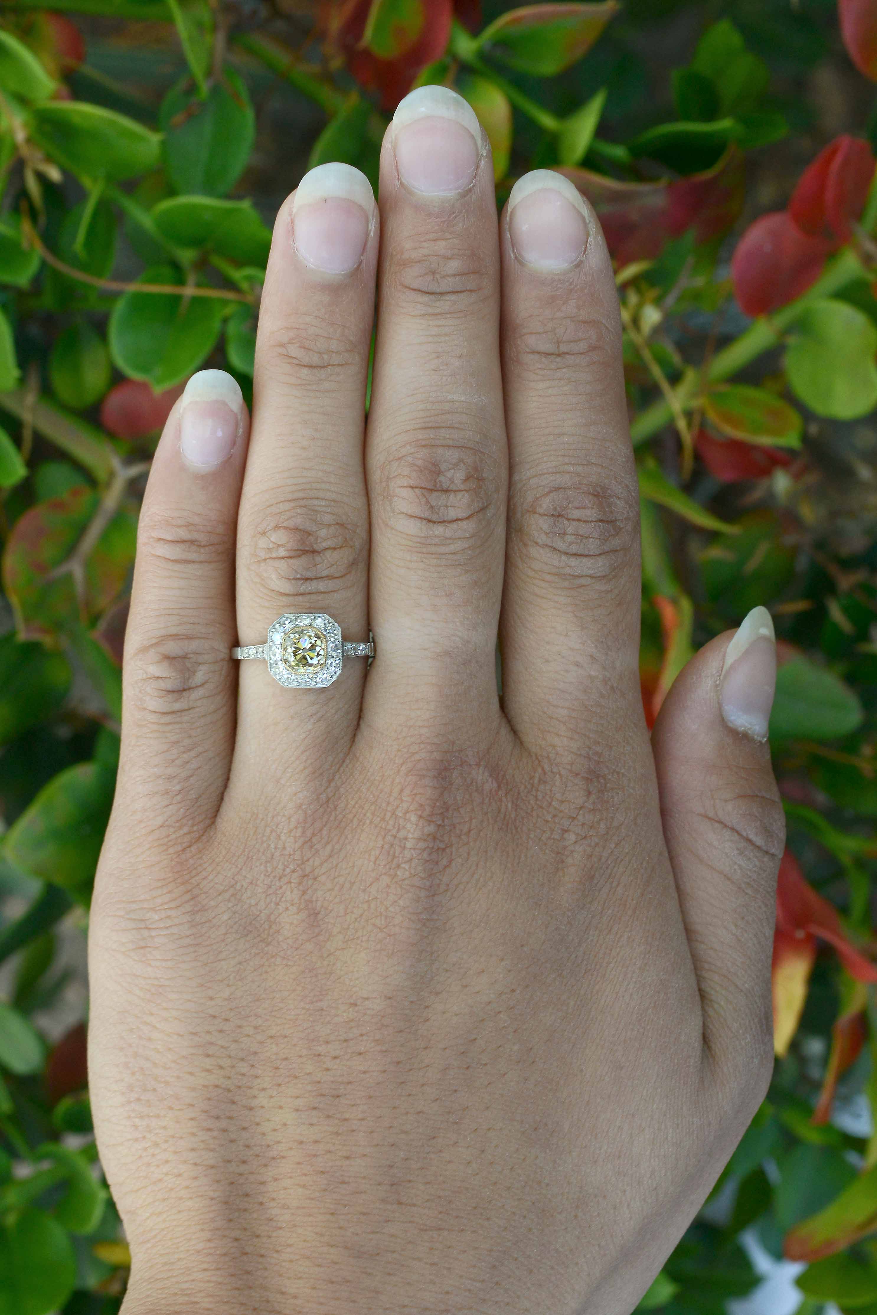 A light yellow diamond halo, Art Deco style engagement ring.