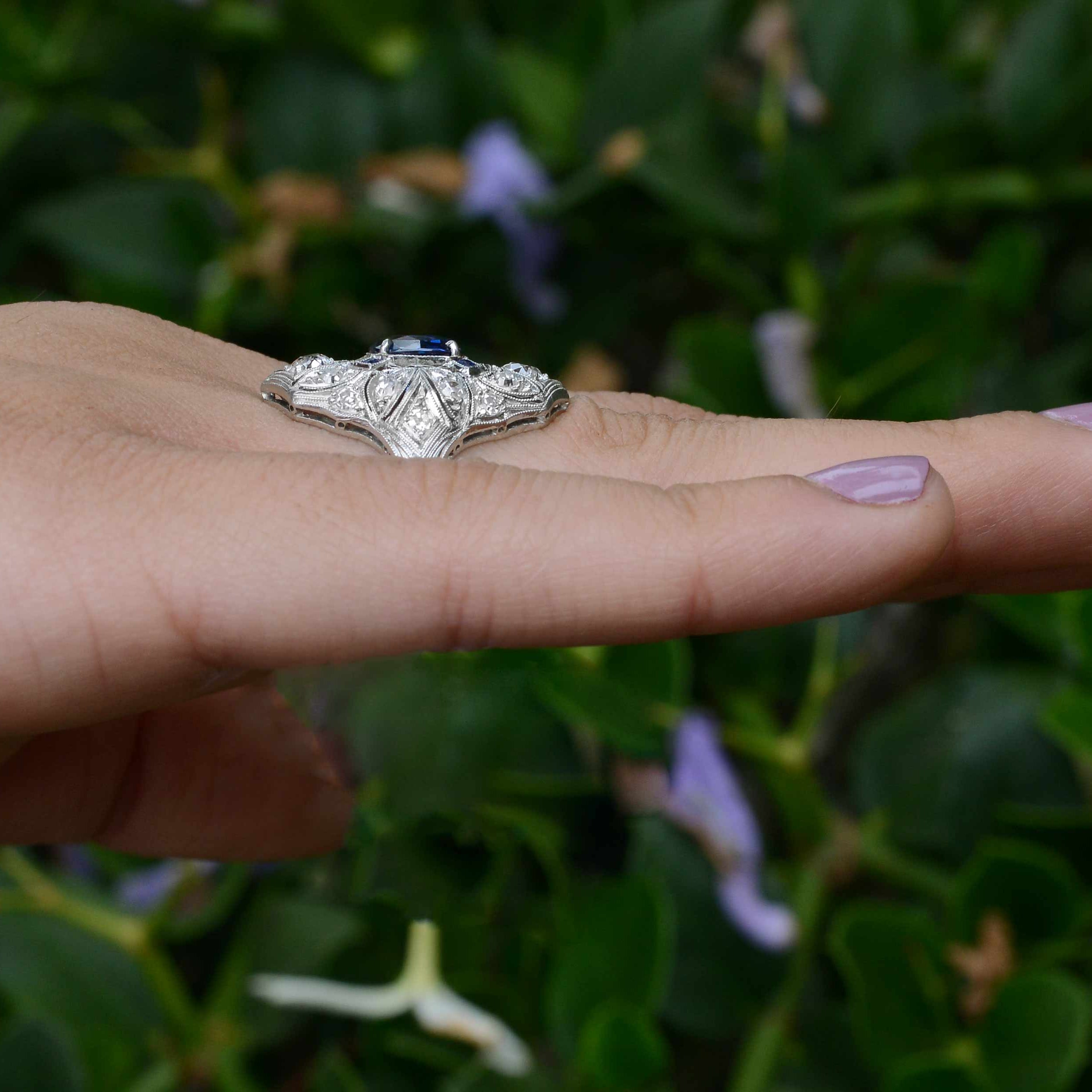 A long, platinum Edwardian diamonds and blue sapphires antique engagement ring.