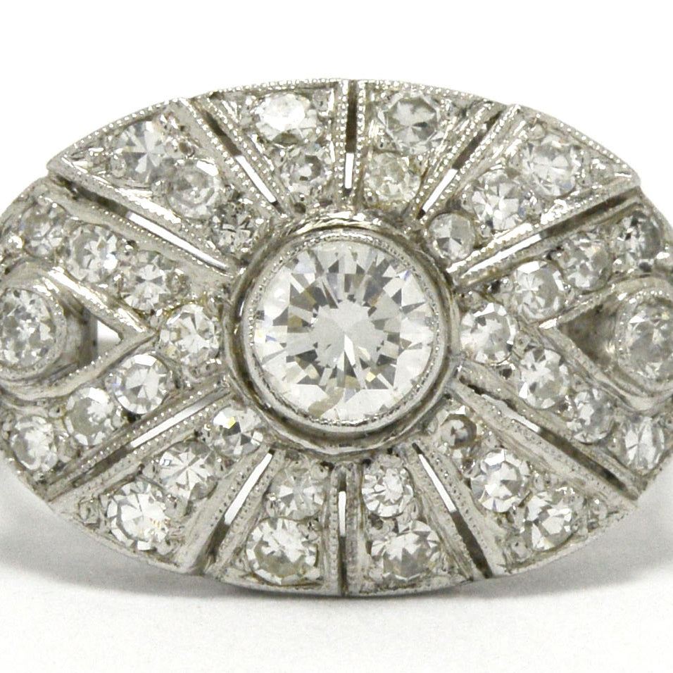An oval Art Deco statement ring with a transitional round brilliant diamond.