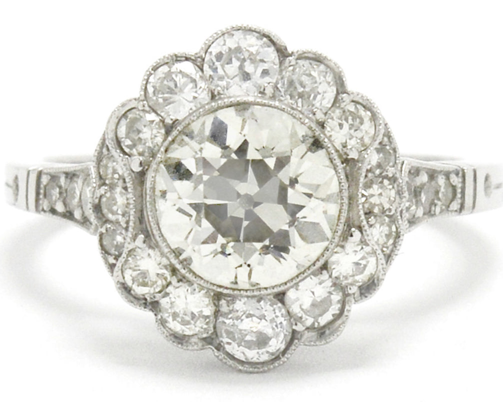 This old European cut diamond cluster engagement ring looks like a flower.
