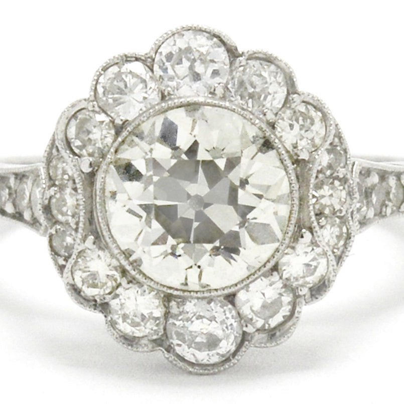 This old European cut diamond cluster engagement ring looks like a flower.