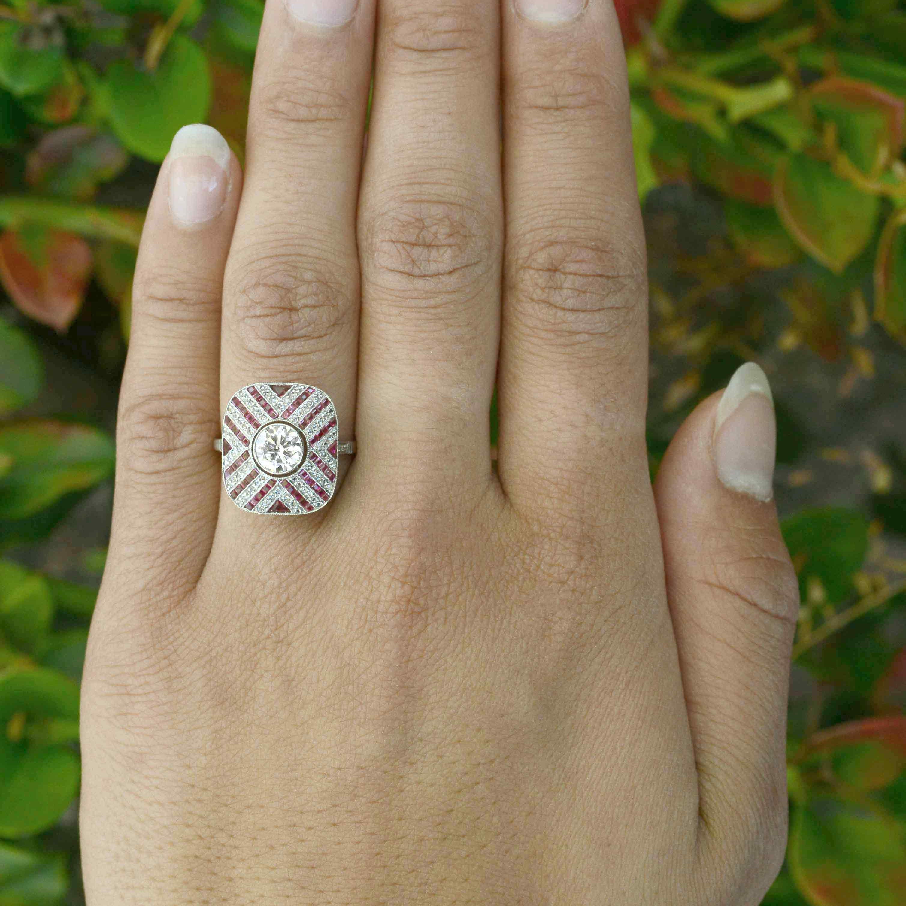 French cut rubies rose cut diamonds accent the center diamond in this engagement ring.