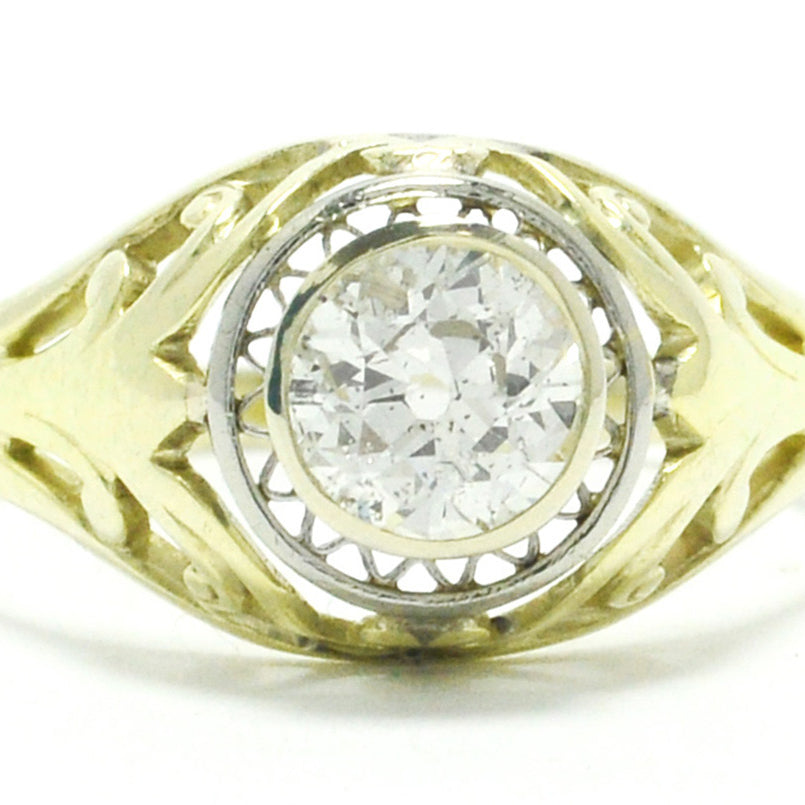A 14k gold antique old mine brilliant diamond illusion engagement ring.