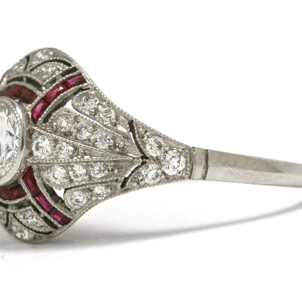 A bezel set round brilliant diamond wedding ring with ruby stripes.