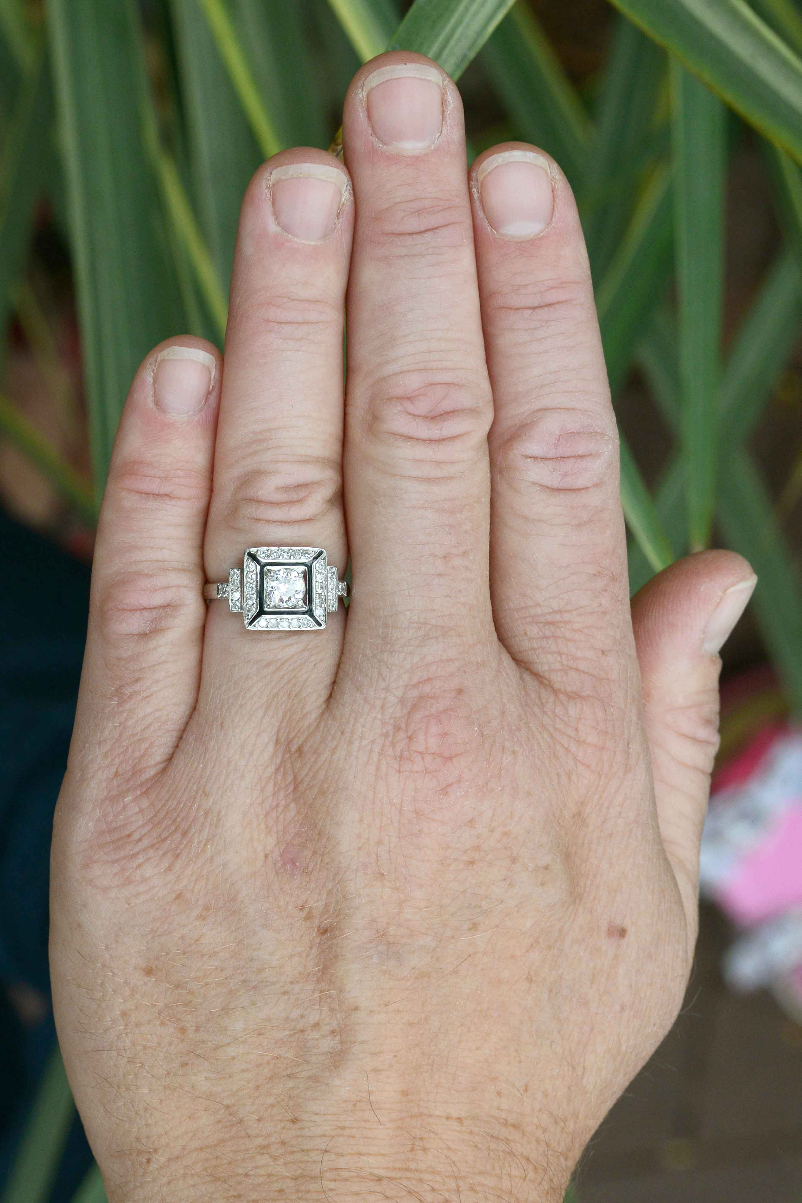 An old European diamond is surrounded by a square shaped enamel border.