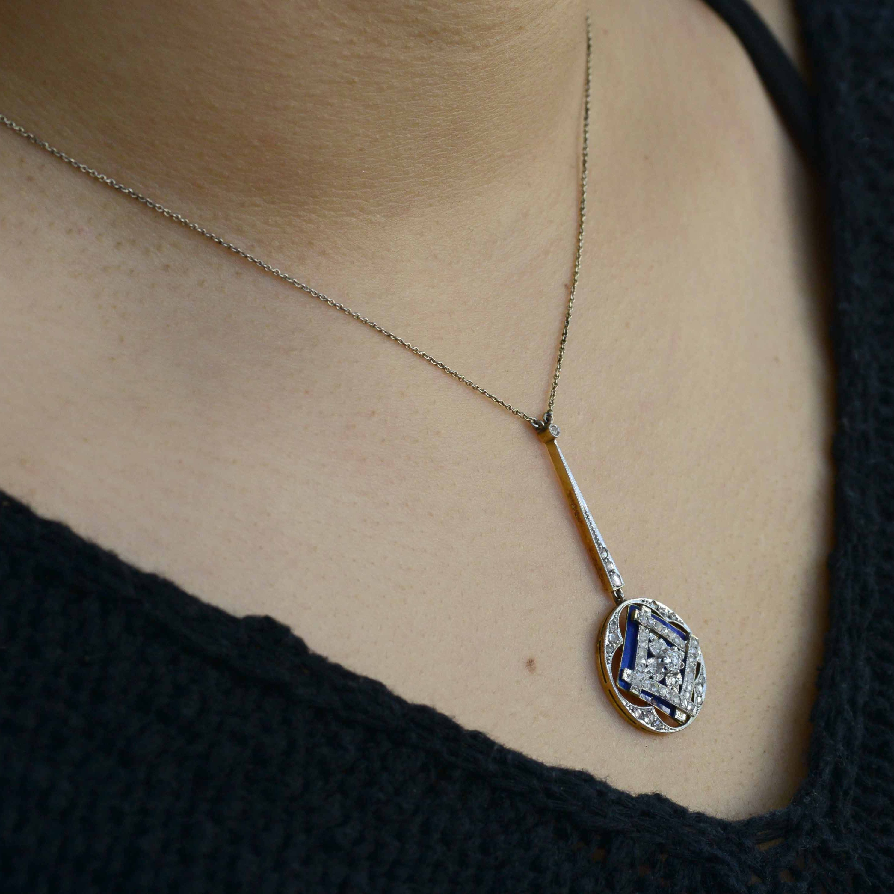 Blue enamel accents this square, geometric diamond pendant necklace.