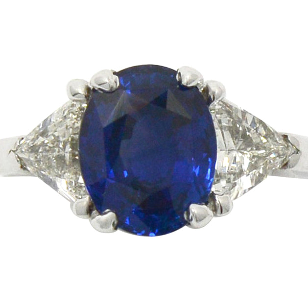 An oval 3 carat blue ceylon sapphire, three stone engagement ring.