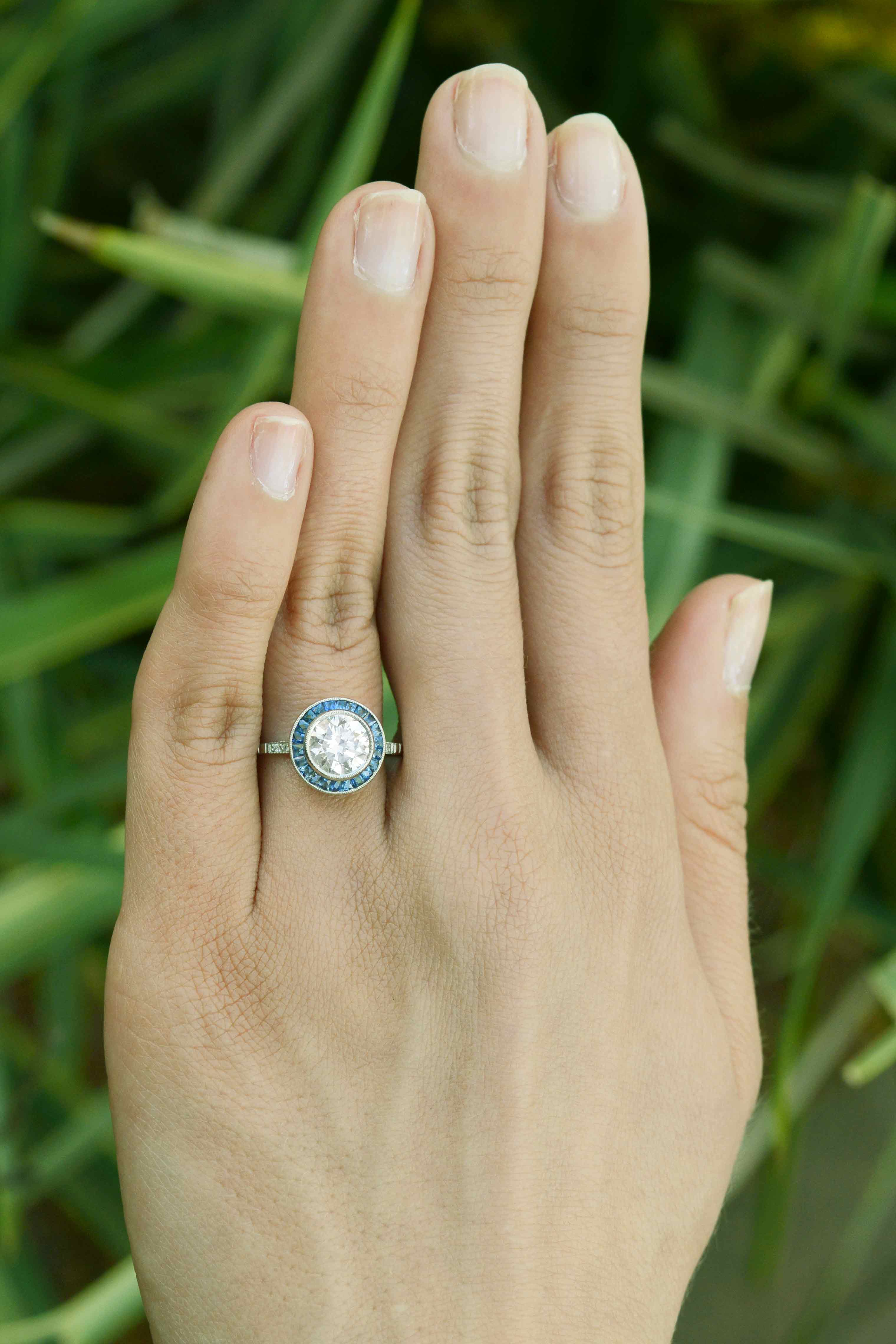 1.50 carat diamond target ring with blue sapphires.
