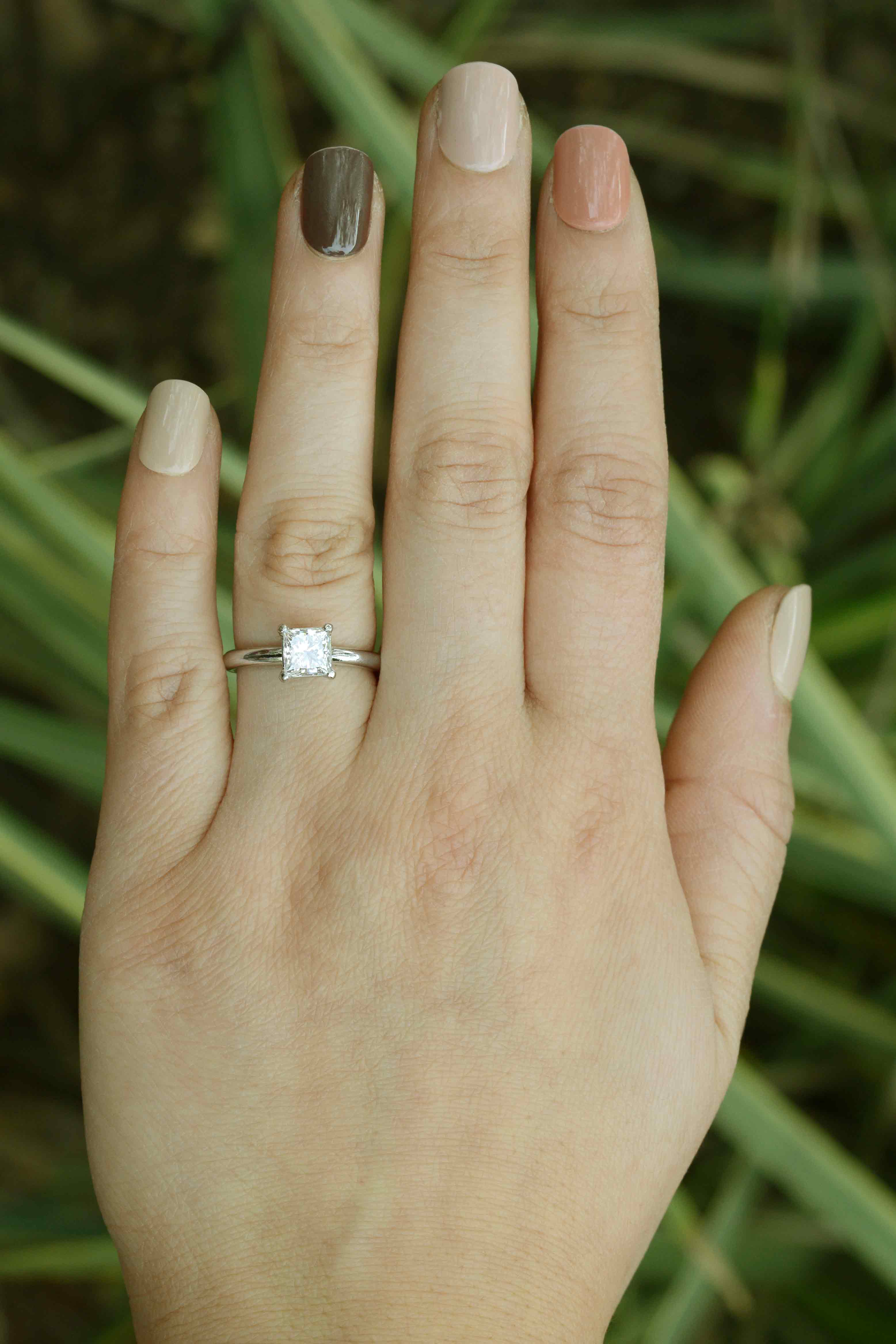 This GIA cerified princess diamond measures over 1 carat, set in a single stone solitaire mounting.