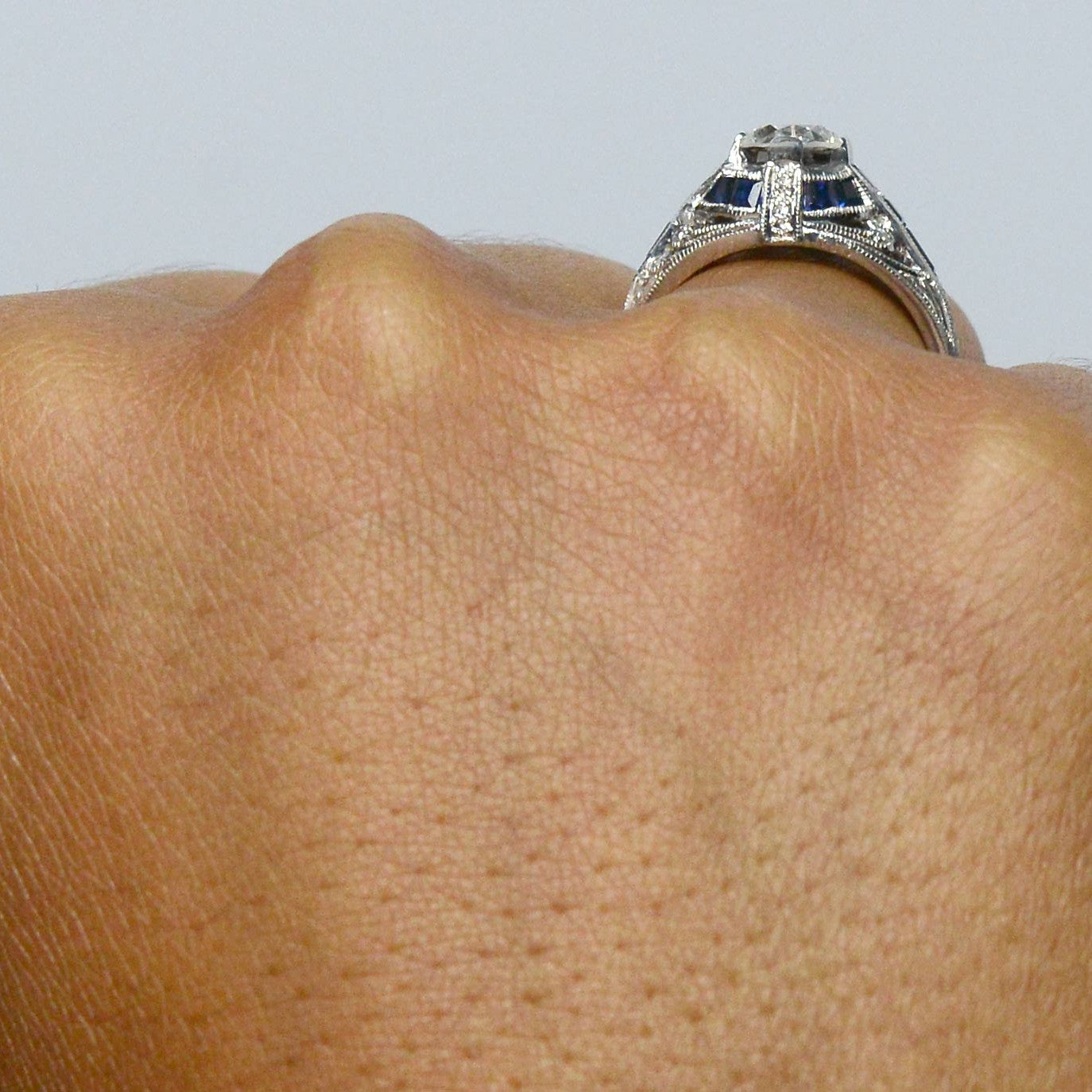 There is a parallel blue sapphire stripe in the middle of this white gold ring.