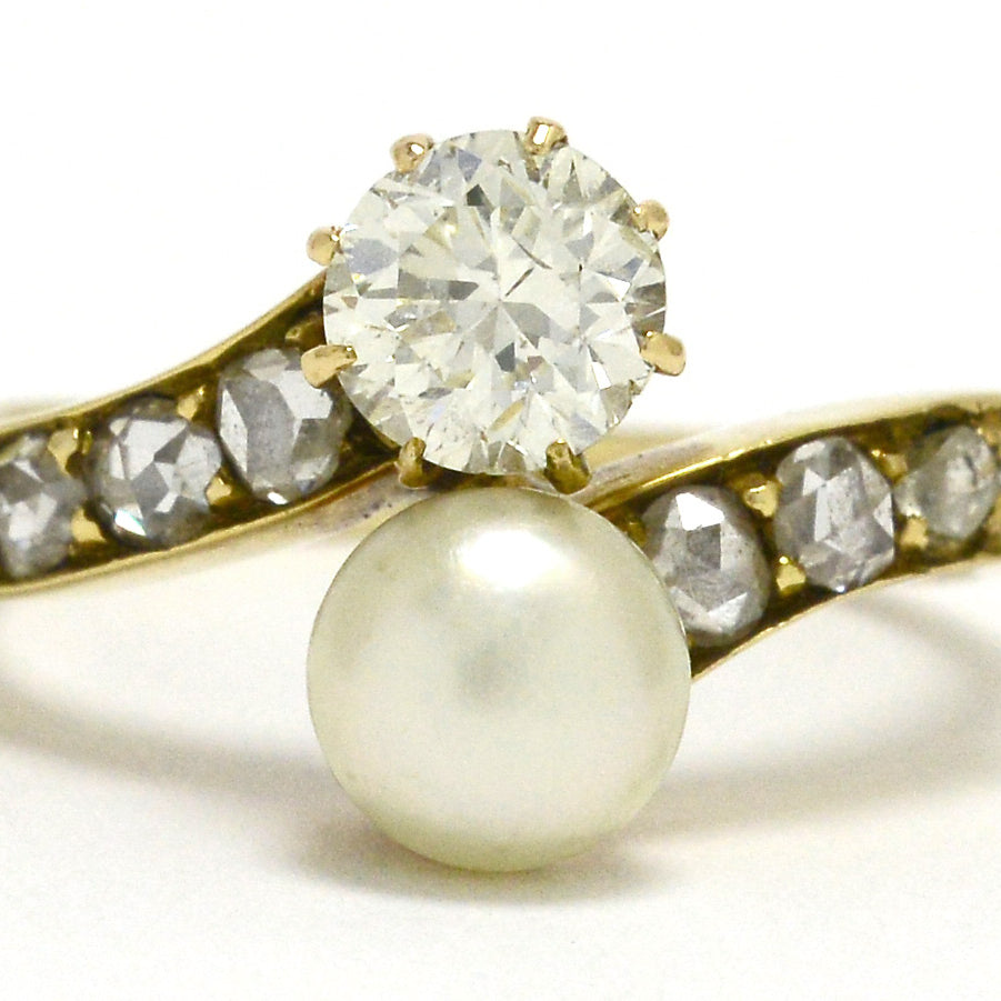 A 2 stone pearl and diamonds solitaire engagement ring.