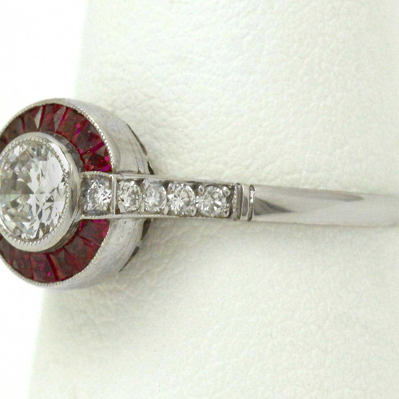 An old European brilliant diamond set in a ruby target Art Deco wedding ring design.