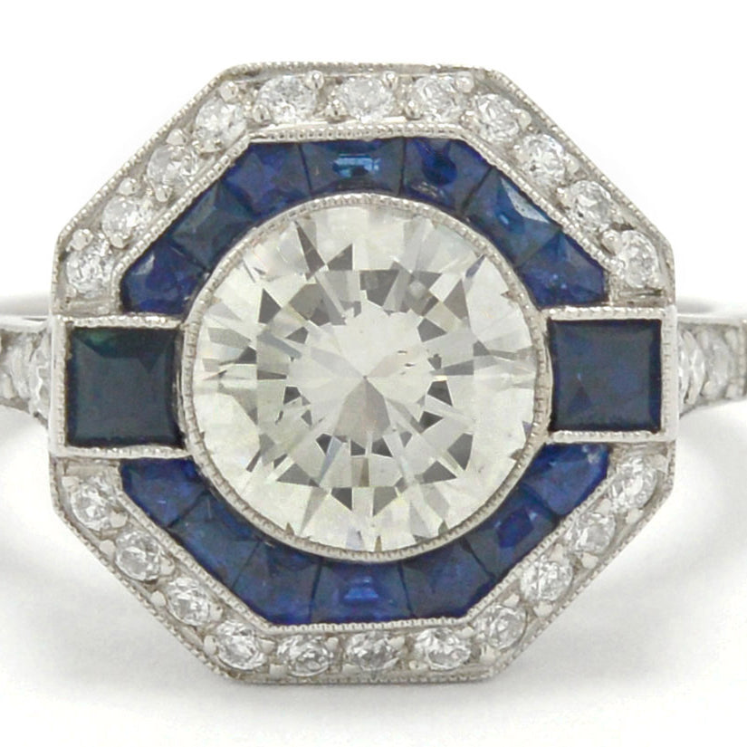 A round diamond with French and calibre cut sapphires engagement ring.