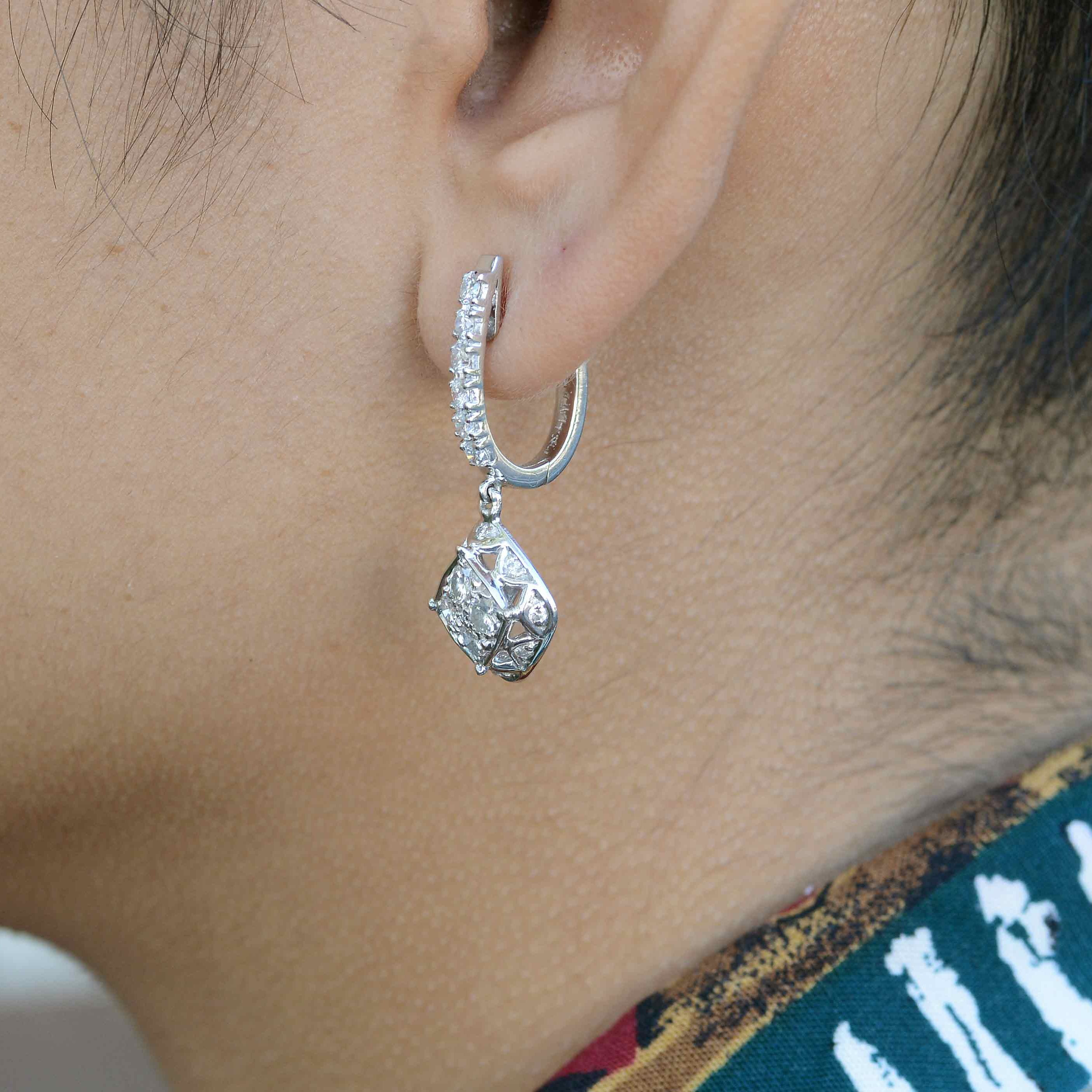 18k white gold diamond earrings sparkling in the sunlight.