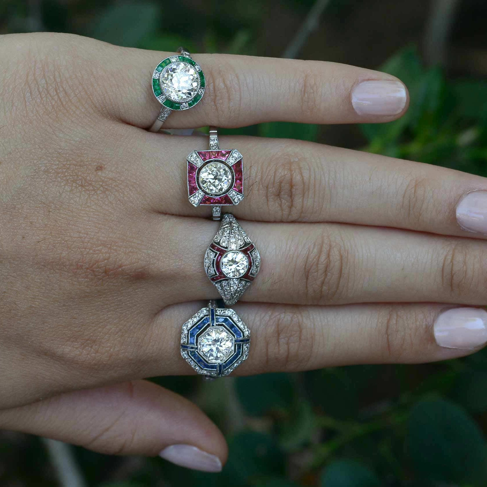Art Deco style diamond and gem halo engagemnt rings.